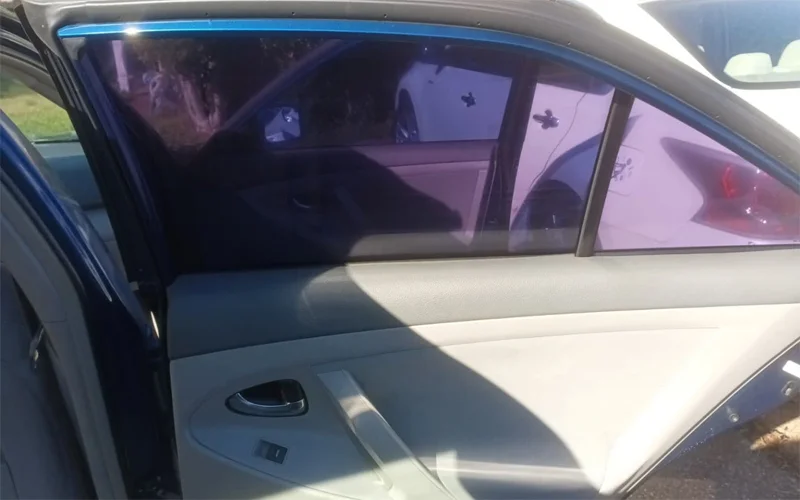 Rear and side window tint removal on a 2010 Toyota Camry showing clear glass after removing purple, bubbled tint — Black Shield Tint.