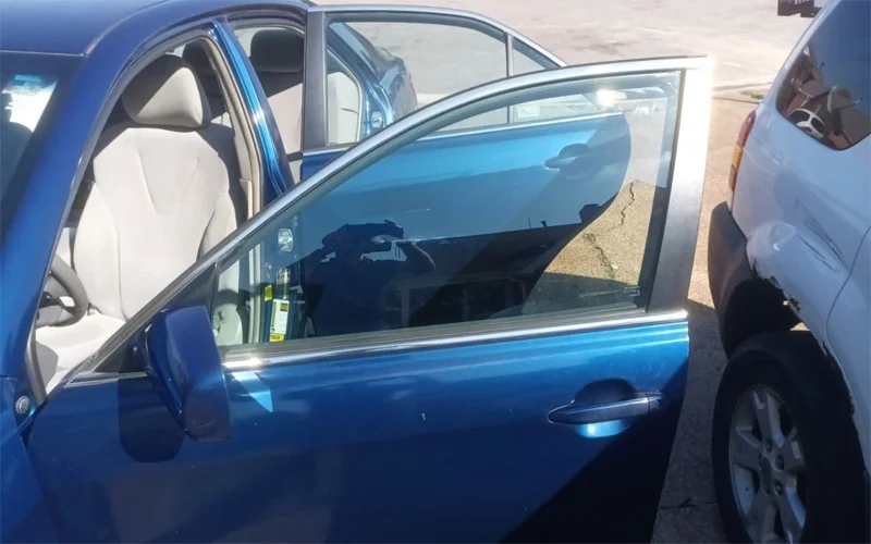 Rear and side window tint removal on a 2010 Toyota Camry showing clear glass after removing purple, bubbled tint — Black Shield Tint.